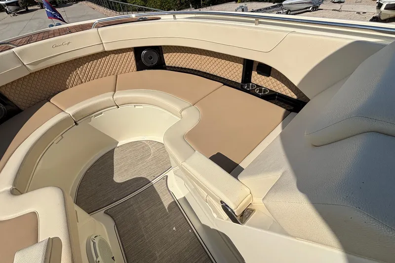 Slide: The Image of 2021 Chris-Craft Calypso 35 boat interior with beige seating and cup holders. - 56
