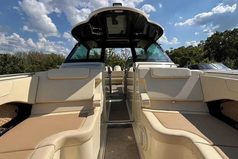 Slide: The Image of 2021 Chris-Craft Calypso 35 boat interior with beige seating under a blue sky. - 58