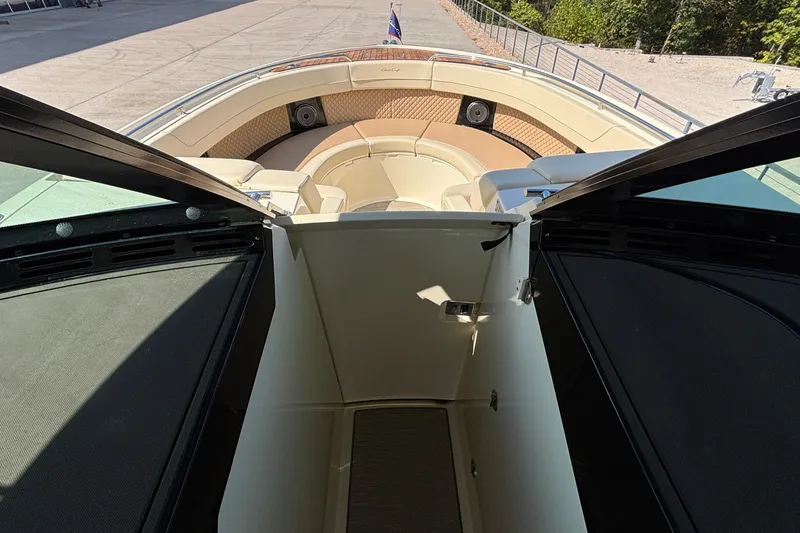 Slide: The Image of 2021 Chris-Craft Calypso 35 boat interior with open cabin door and seating area. - 60