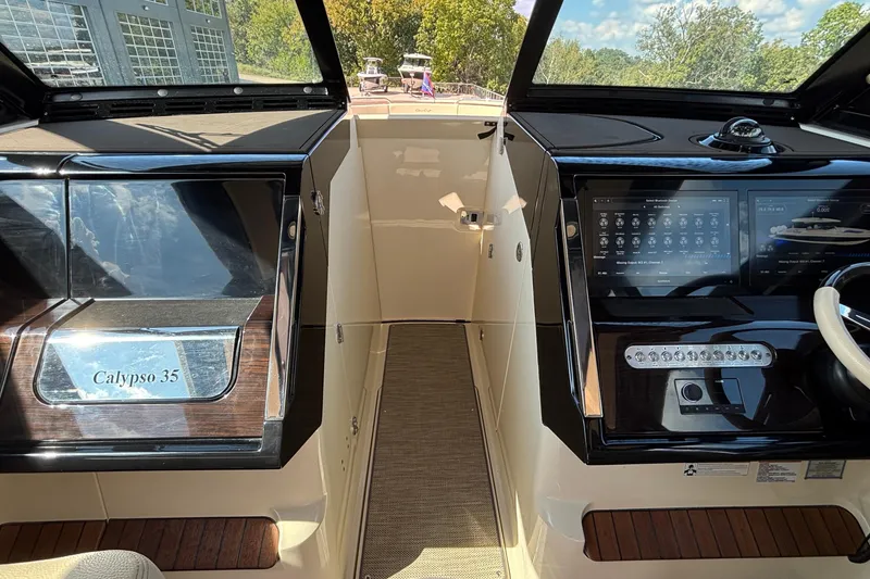Slide: The Image of 2021 Chris-Craft Calypso 35 boat interior with modern dashboard and controls. - 61