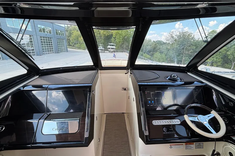 Slide: The Image of 2021 Chris-Craft Calypso 35 helm with modern navigation controls and sleek design. - 63