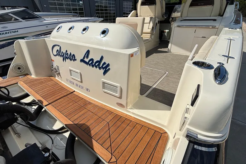 Slide: The Image of 2021 Chris-Craft Calypso 35 boat, named "Calypso Lady," docked with teak deck. - 8