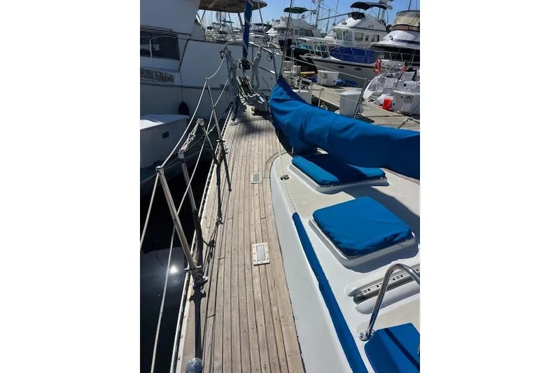 Slide: The Image of 1987 Tayana Vancouver 42 sailboat deck with blue covers, docked in marina. - 10