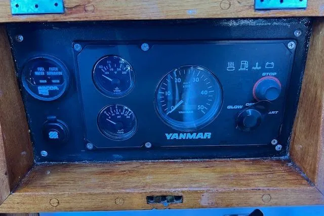 Slide: The Image of Yanmar engine control panel on 1987 Tayana Vancouver 42 sailboat, featuring gauges and switches. - 13