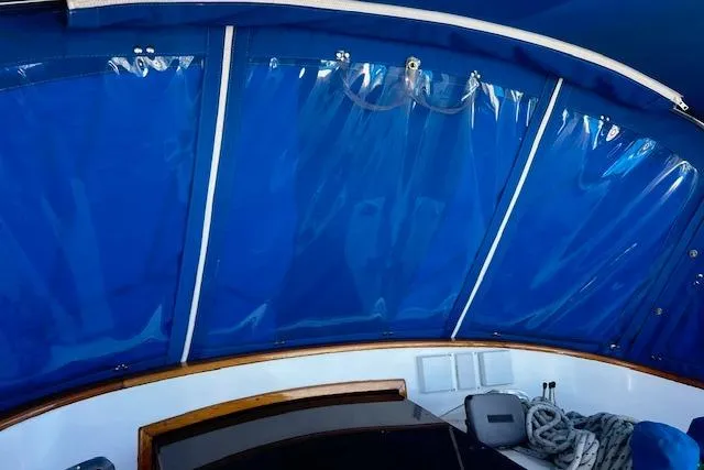 Slide: The Image of Blue canopy interior of 1987 Tayana Vancouver 42 sailboat with ropes and seating. - 14
