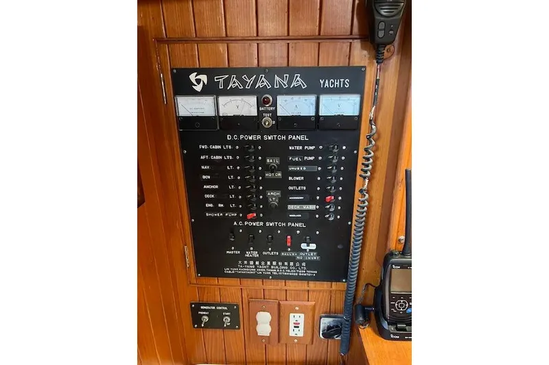 Slide: The Image of Control panel of a 1987 Tayana Vancouver 42 yacht with various switches and meters. - 16