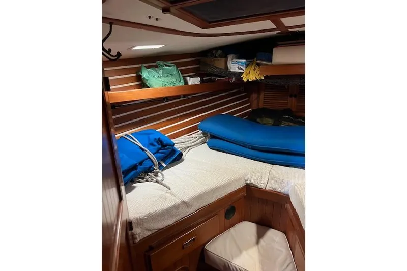 Slide: The Image of Cozy cabin interior of 1987 Tayana Vancouver 42 sailboat with wooden paneling and storage. - 21