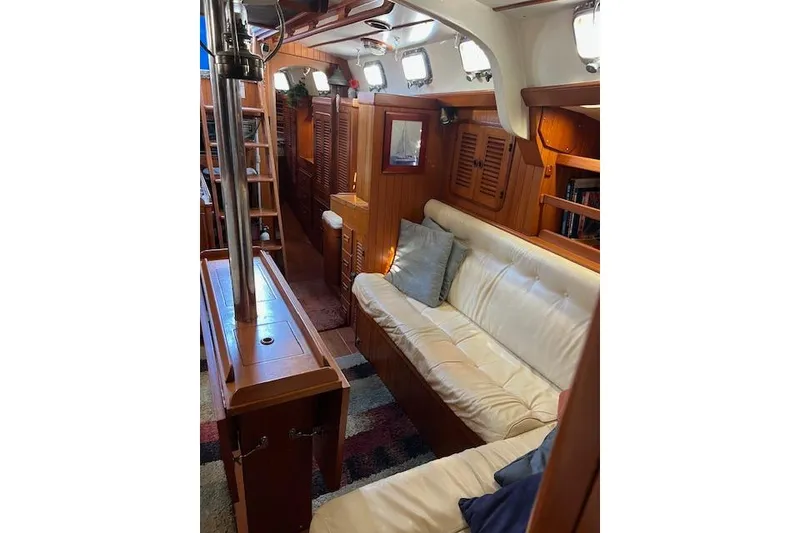 Slide: The Image of 1987 Tayana Vancouver 42 yacht interior with wooden finish and white leather seating. - 24