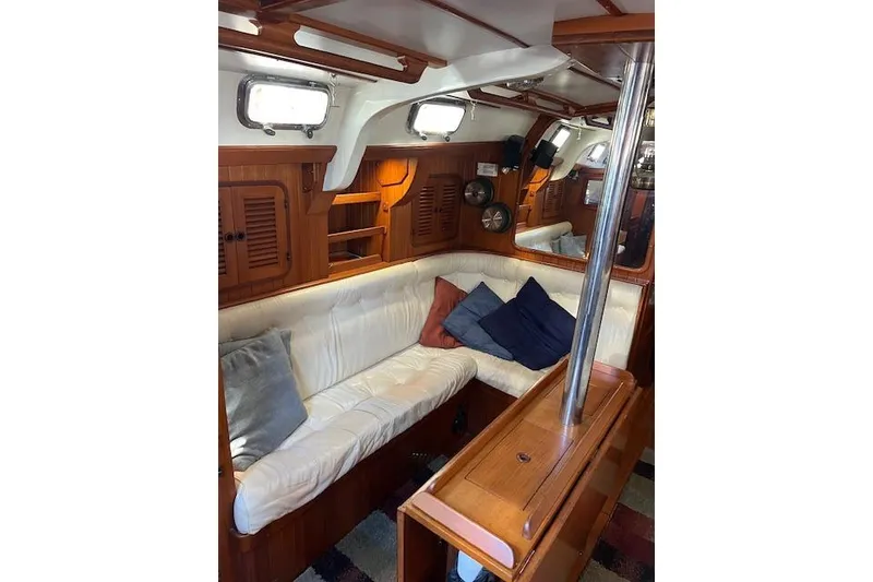 Slide: The Image of Interior of 1987 Tayana Vancouver 42 yacht with cozy seating and wooden cabinetry. - 25