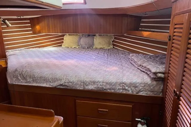 Slide: The Image of Cozy cabin interior of 1987 Tayana Vancouver 42 sailboat with wooden paneling and bed. - 28