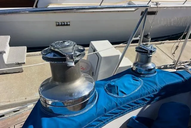 Slide: The Image of Winches on 1987 Tayana Vancouver 42 sailboat, featuring blue canvas covers. - 35