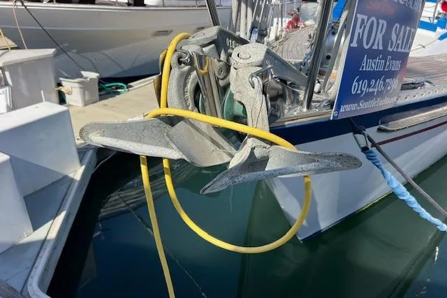 Slide: The Image of Anchor of 1987 Tayana Vancouver 42 sailboat docked, with yellow rope and "For Sale" sign. - 5