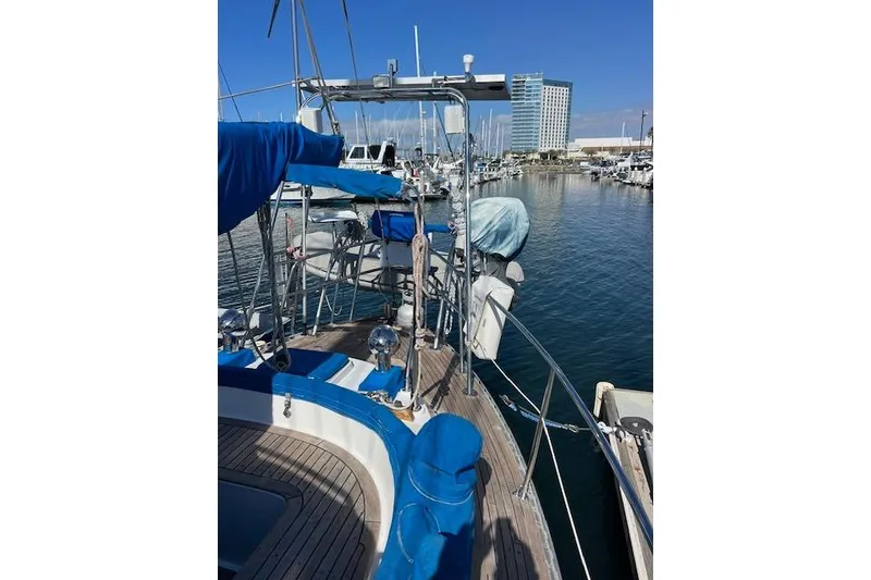 Slide: The Image of 1987 Tayana Vancouver 42 sailboat docked in a marina, clear blue sky. - 7