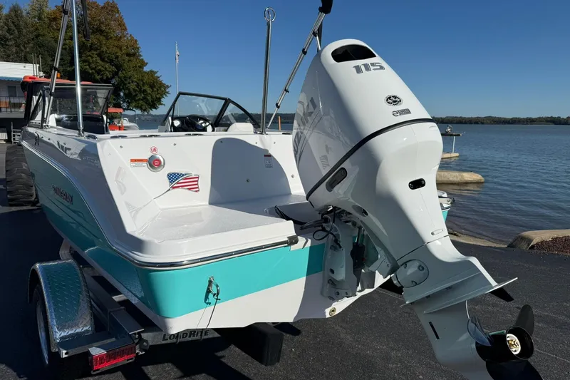 Slide: The Image of 2026 Stingray 172 DC boat with outboard motor, docked by a serene lake. - 3