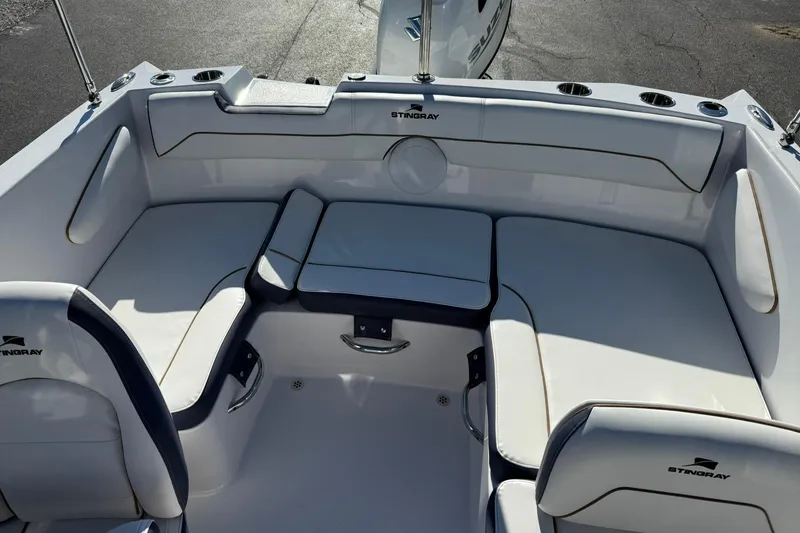 Slide: The Image of 2026 Stingray 172 DC boat interior with white cushioned seating and cup holders. - 8