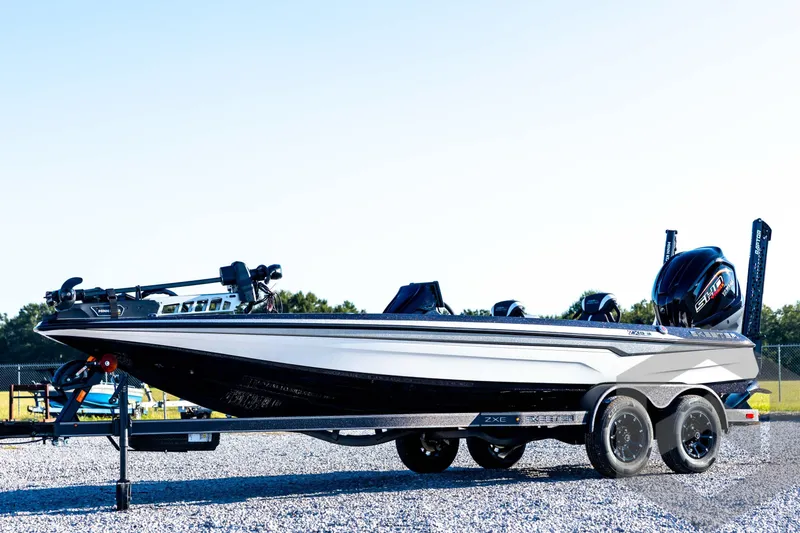 The Image of 2026 Skeeter ZXE21 bass boat with dual engines on a trailer. - 1