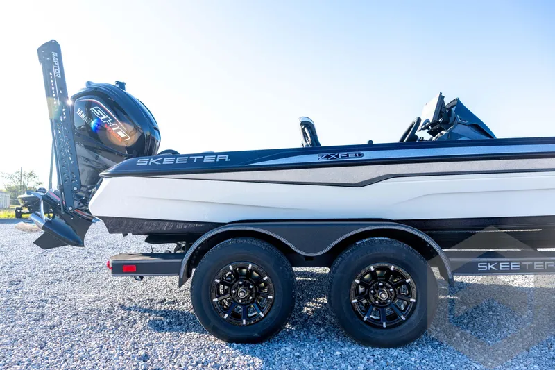 Slide: The Image of 2026 Skeeter ZXE21 boat on trailer, featuring dual wheels and powerful outboard motor. - 14