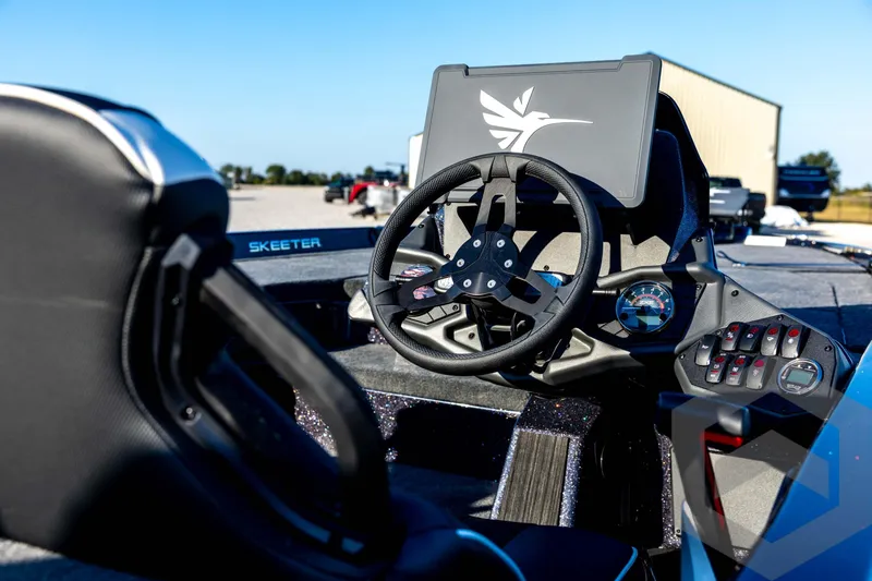 Slide: The Image of 2026 Skeeter ZXE21 boat cockpit with steering wheel and control panel. - 17