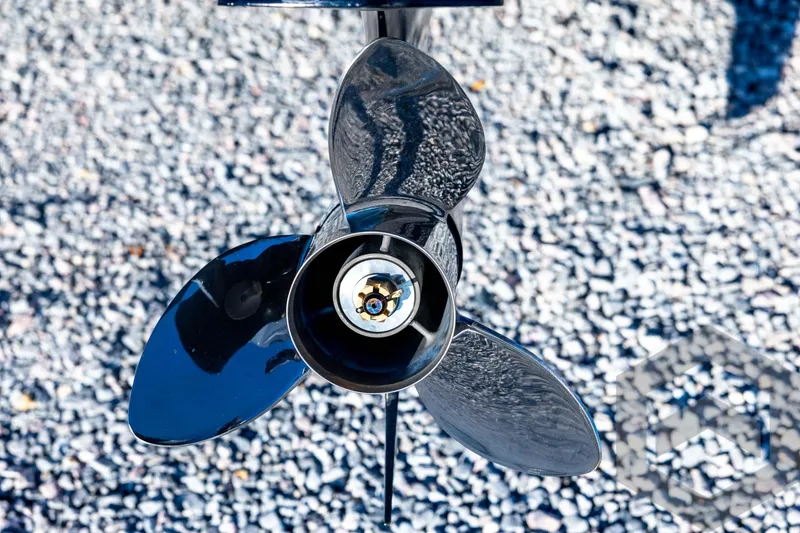 Slide: The Image of Skeeter ZXE21 2026 boat propeller on gravel background, close-up view. - 24