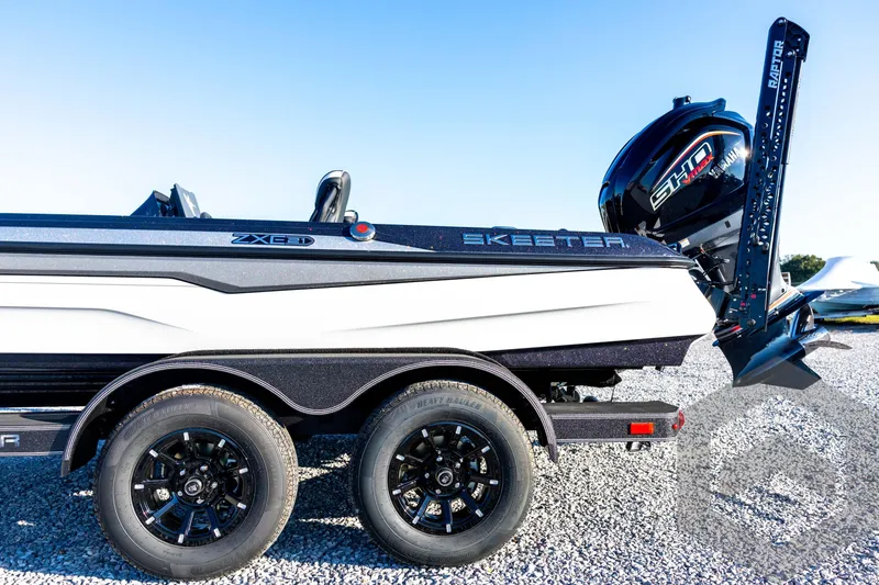 Slide: The Image of 2026 Skeeter ZXE21 boat on trailer with Yamaha engine, parked on gravel. - 33