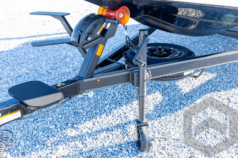 Slide: The Image of Trailer hitch and wheel assembly of 2026 Skeeter ZXE21 on gravel surface. - 38