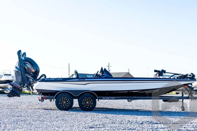 Slide: The Image of 2026 Skeeter ZXE21 boat on trailer, side view, parked on gravel. - 4