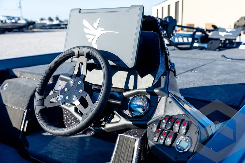 Slide: The Image of 2026 Skeeter ZXE21 boat dashboard with steering wheel and control panel. - 42