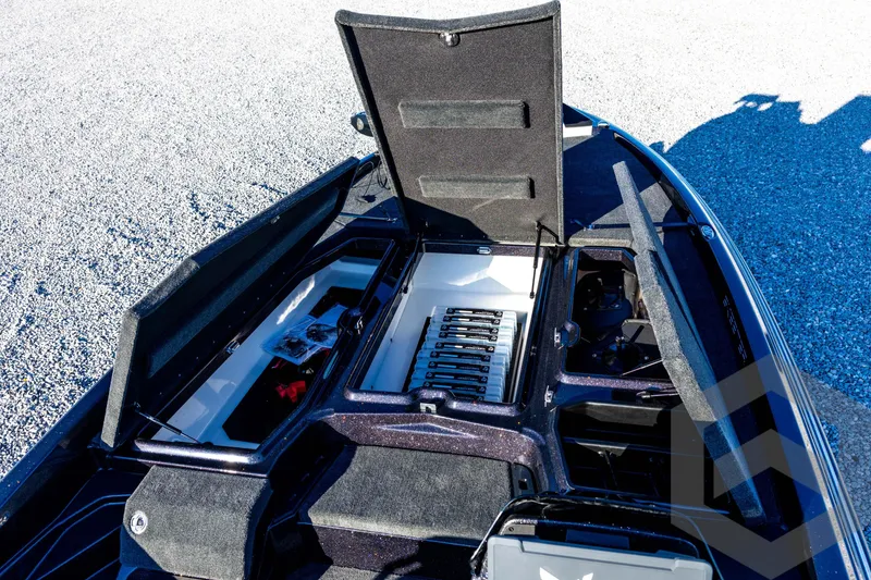 Slide: The Image of 2026 Skeeter ZXE21 boat storage compartments open, showcasing organized interior layout. - 51