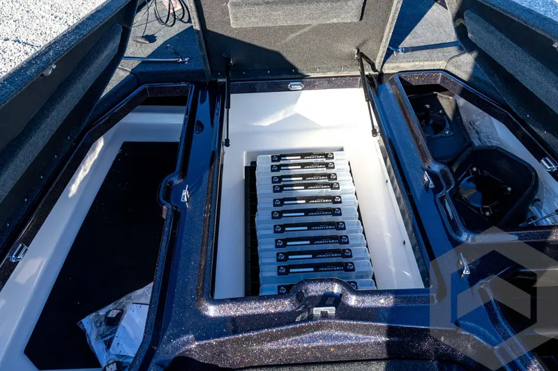 Slide: The Image of 2026 Skeeter ZXE21 boat storage compartments with organized battery setup. - 54