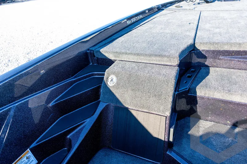 Slide: The Image of 2026 Skeeter ZXE21 boat interior with carpeted deck and storage compartments. - 59