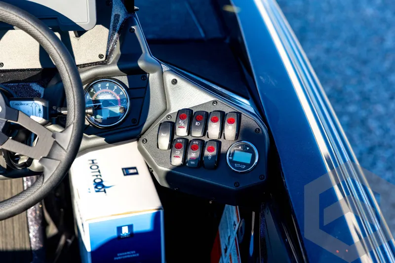 Slide: The Image of Control panel of 2026 Skeeter ZXE21 boat with steering wheel and switches. - 67
