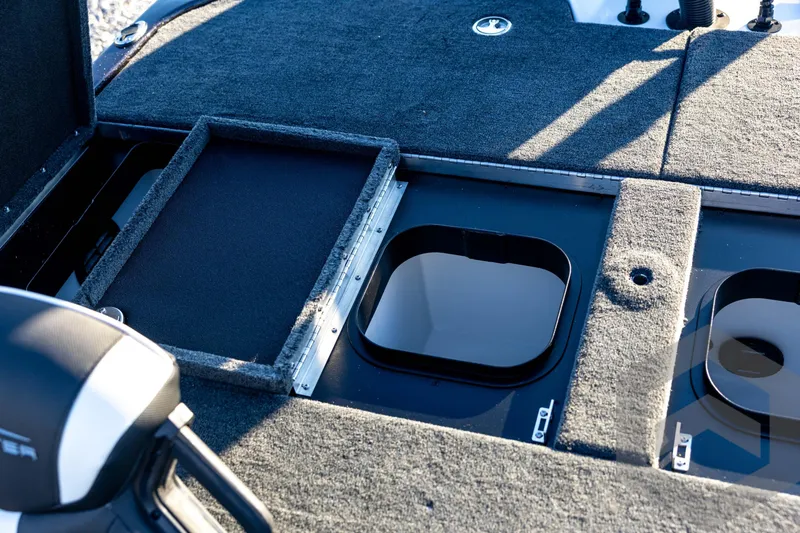 Slide: The Image of 2026 Skeeter ZXE21 boat deck with open storage compartments and motor detail. - 75