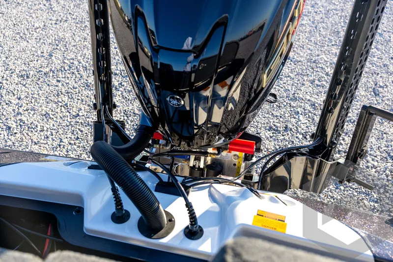 Slide: The Image of 2026 Skeeter ZXE21 boat engine close-up with sleek black design on gravel background. - 79