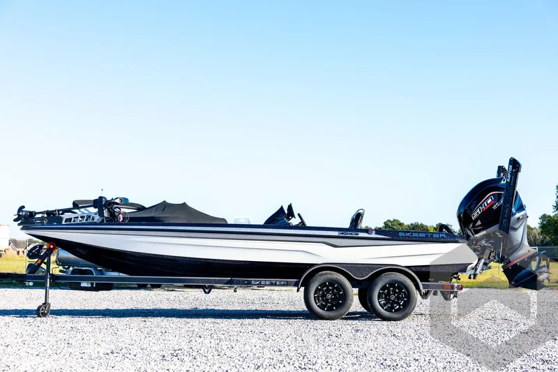 Slide: The Image of 2026 Skeeter ZXE21 boat on trailer, side view, outdoors on gravel. - 8