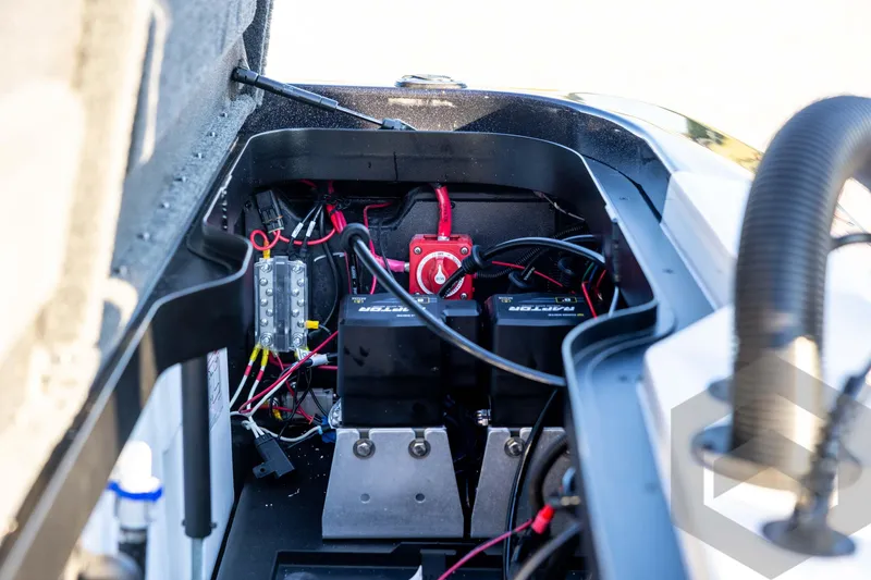 Slide: The Image of 2026 Skeeter ZXE21 boat battery compartment with wiring and components. - 83