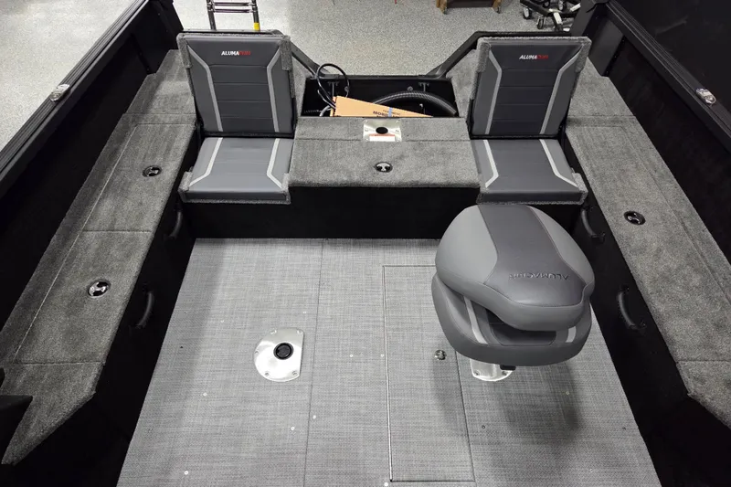 Slide: The Image of 2026 Alumacraft Competitor 185X Sport interior with seating and storage compartments. - 10