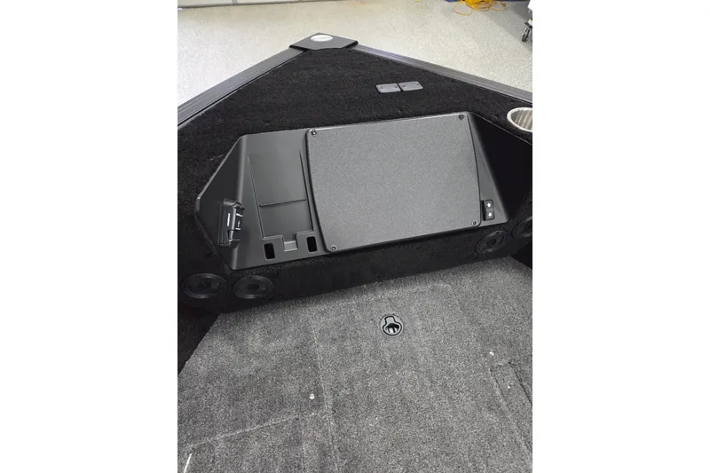 Slide: The Image of Interior view of 2026 Alumacraft Competitor 185X Sport boat, featuring storage compartment. - 6