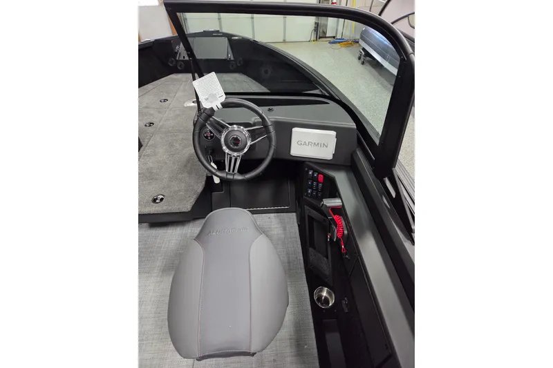 Slide: The Image of 2026 Alumacraft Competitor 185X Sport boat interior with Garmin navigation system. - 8