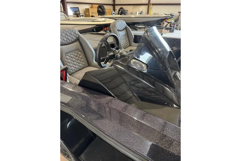 Slide: The Image of 2025 iKon VLX20 boat interior with sleek design and modern steering console. - 3