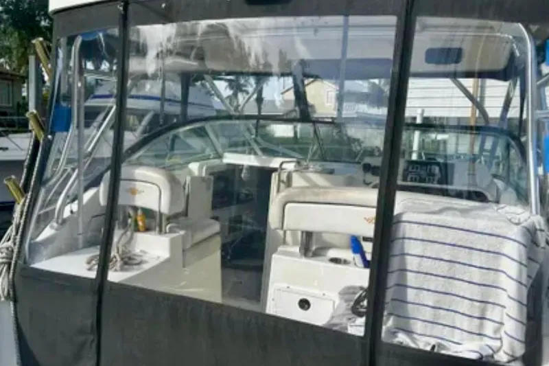 Slide: The Image of 2002 Wellcraft 290 Coastal boat interior with seating and dashboard view. - 17