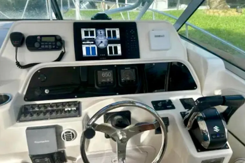 Slide: The Image of Control panel of a 2002 Wellcraft 290 Coastal boat with steering wheel and navigation equipment. - 18