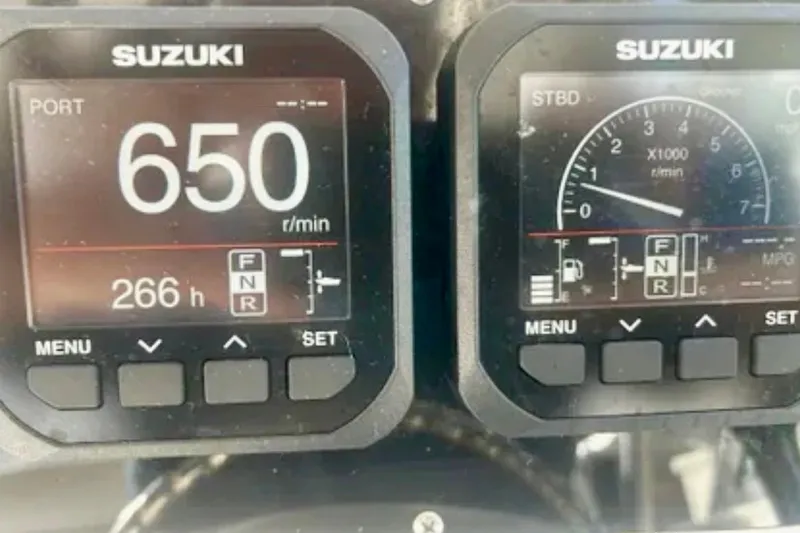 Slide: The Image of Suzuki engine display on 2002 Wellcraft 290 Coastal, showing 650 RPM and 266 hours. - 19
