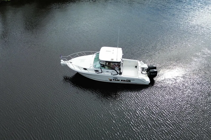 Slide: The Image of 2002 Wellcraft 290 Coastal boat cruising on calm water, aerial view. - 4