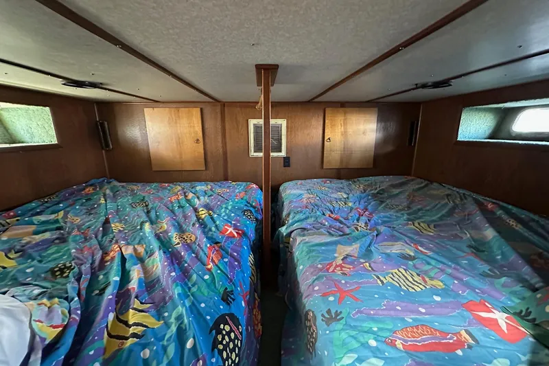 Slide: The Image of Interior of 1987 Hilburn 14x45 with colorful marine-themed bedding. - 11