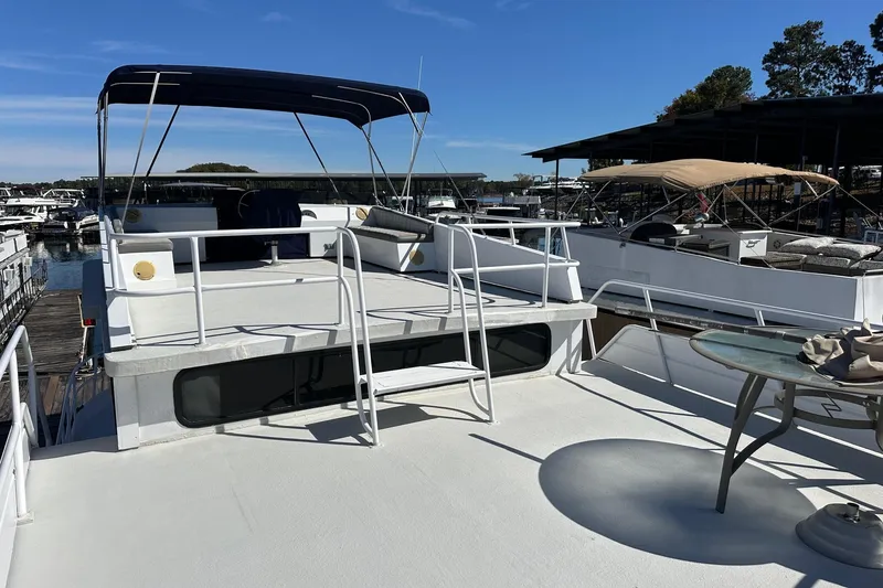Slide: The Image of 1987 Hilburn 14x45 houseboat with upper deck and canopy at marina. - 15
