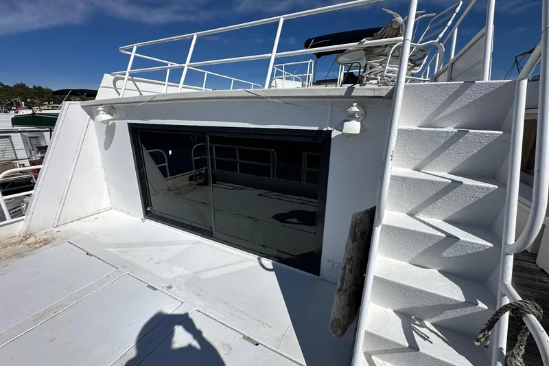 Slide: The Image of 1987 Hilburn 14x45 boat deck with stairs and outdoor seating area. - 16