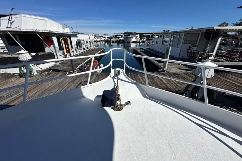 Slide: The Image of Bow view of 1987 Hilburn 14x45 houseboat docked at marina. - 3