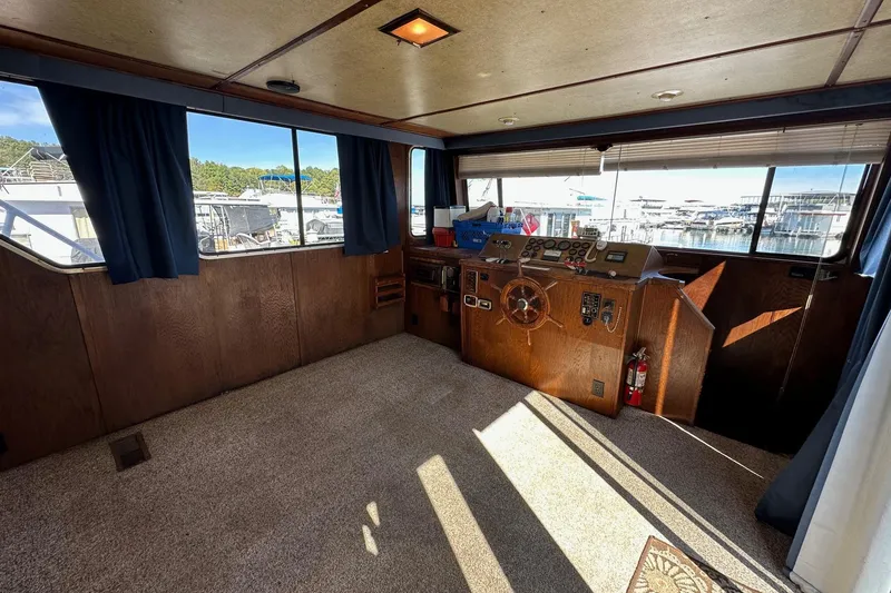 Slide: The Image of Interior of 1987 Hilburn 14x45 boat with helm, windows, and carpeted floor. - 5