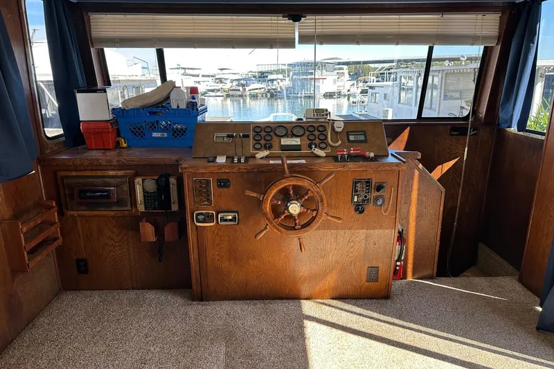 Slide: The Image of 1987 Hilburn 14x45 boat helm with wooden steering wheel and control panel. - 6
