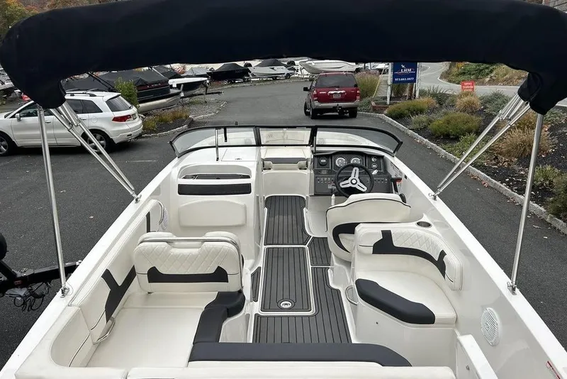 Slide: The Image of 2022 Bayliner VR6 Bowrider OB with spacious seating and sleek design in a parking area. - 1